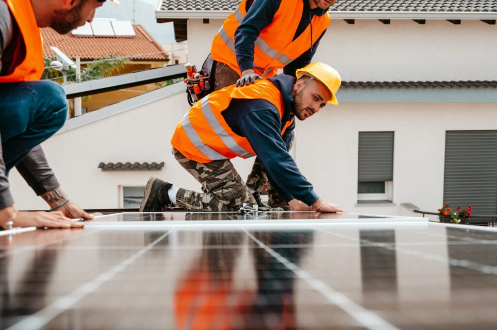 Workers assemble energy system with solar panel for electricity